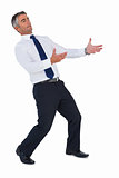 Businessman in suit posing with arms out
