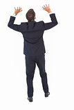 Rear view of a businessman in suit pushing
