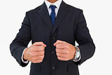 Businessman in suit clenching fists