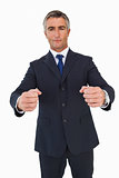 Portrait of a businessman clenching fists
