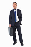 Smiling businessman holding black briefcase