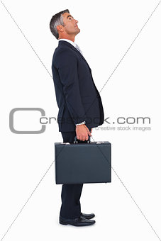 Businessman standing and holding briefcase