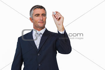 Smiling businessman writing with marker