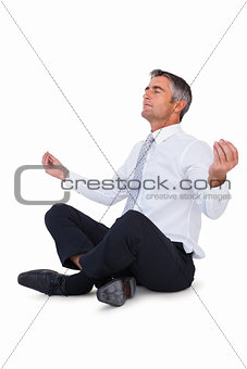 Relaxed businessman in lotus pose
