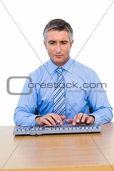 Focused businessman typing on keyboard