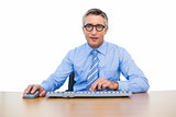 Smiling businessman using computing mouse and keyboard