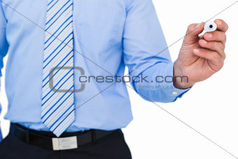 Mid section of a businessman writing with marker