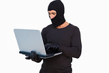 Burglar with leather gloves using laptop