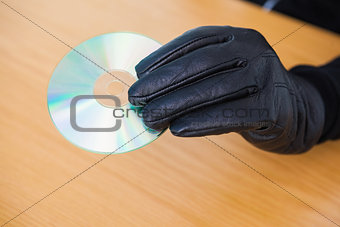 Hacker holding a cd rom