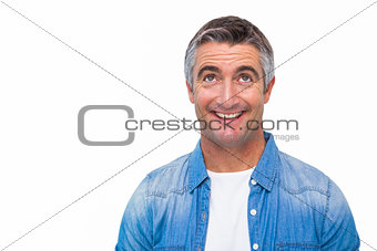 Joyful man in casual clothes looking up