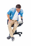 Man sitting on a office chair speaking on megaphone