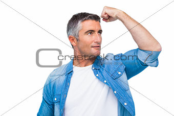 Man with grey hair tensing arm muscle