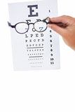 Hand holding glasses for a eye test