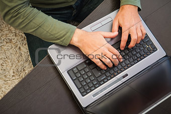 High angle view of a man typing on laptop