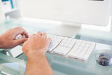Close up of a man typing on keyboard