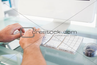 Close up of a man typing on keyboard