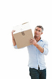 Cheerful man carrying cardboard box