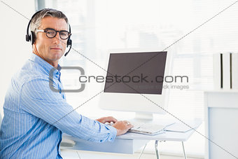 Man with headset using computer