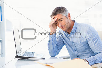 Concentrated man reading a document attentively