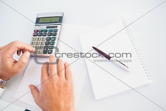 Hand of man using a calculator
