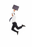 Smiling businessman leaping while briefcase