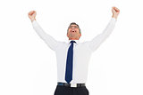 Excited businessman with glasses cheering