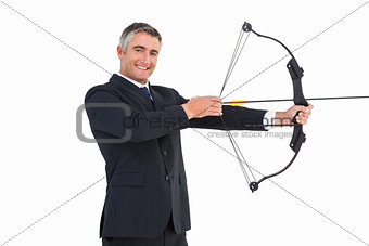 Smiling businessman stretching a bow