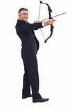 Smiling businessman drawing a bow