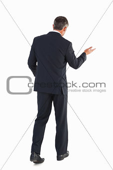 Businessman walking and doing gesture