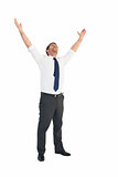 Handsome businessman cheering with arms up