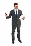 Businessman sending text holding page