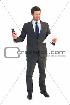 Businessman sending text holding page