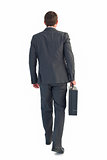 Businessman walking with his briefcase