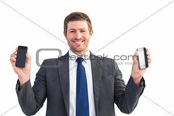 Businessman holding two smart phones