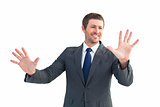 Smiling businessman with hands up