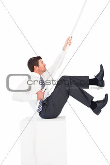 Businessman pulling a rope