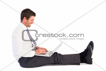 Businessman using laptop and smiling