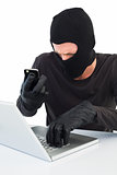 Hacker using laptop and phone