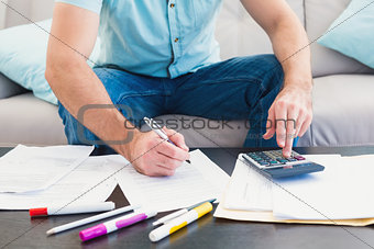 A man counting his bills at home