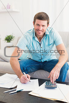 Smiling man counting his bills