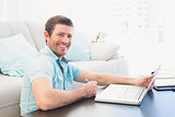 Smiling man with a laptop