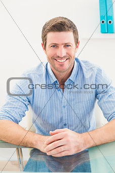 Smiling businessman at his desk