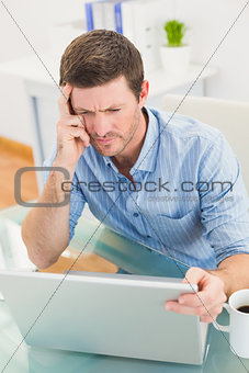 Focused businessman looking at laptop