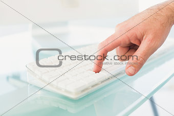 Businessman pushing key on keyboard