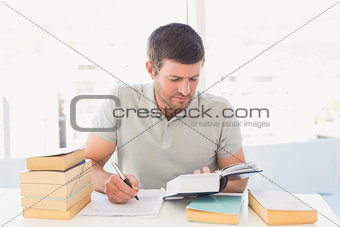 Casual businessman studying at his desk