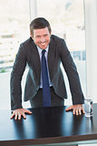 Smiling businessman at his desk