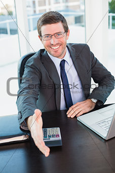Happy businessman offering his hand