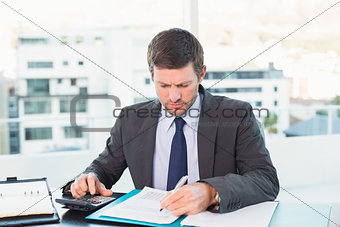 Businessman working on his finances at his desk