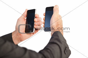 Businessman holding a phone in each hand