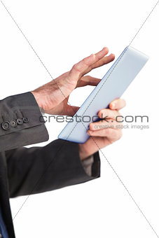 Businessman scrolling on his digital tablet